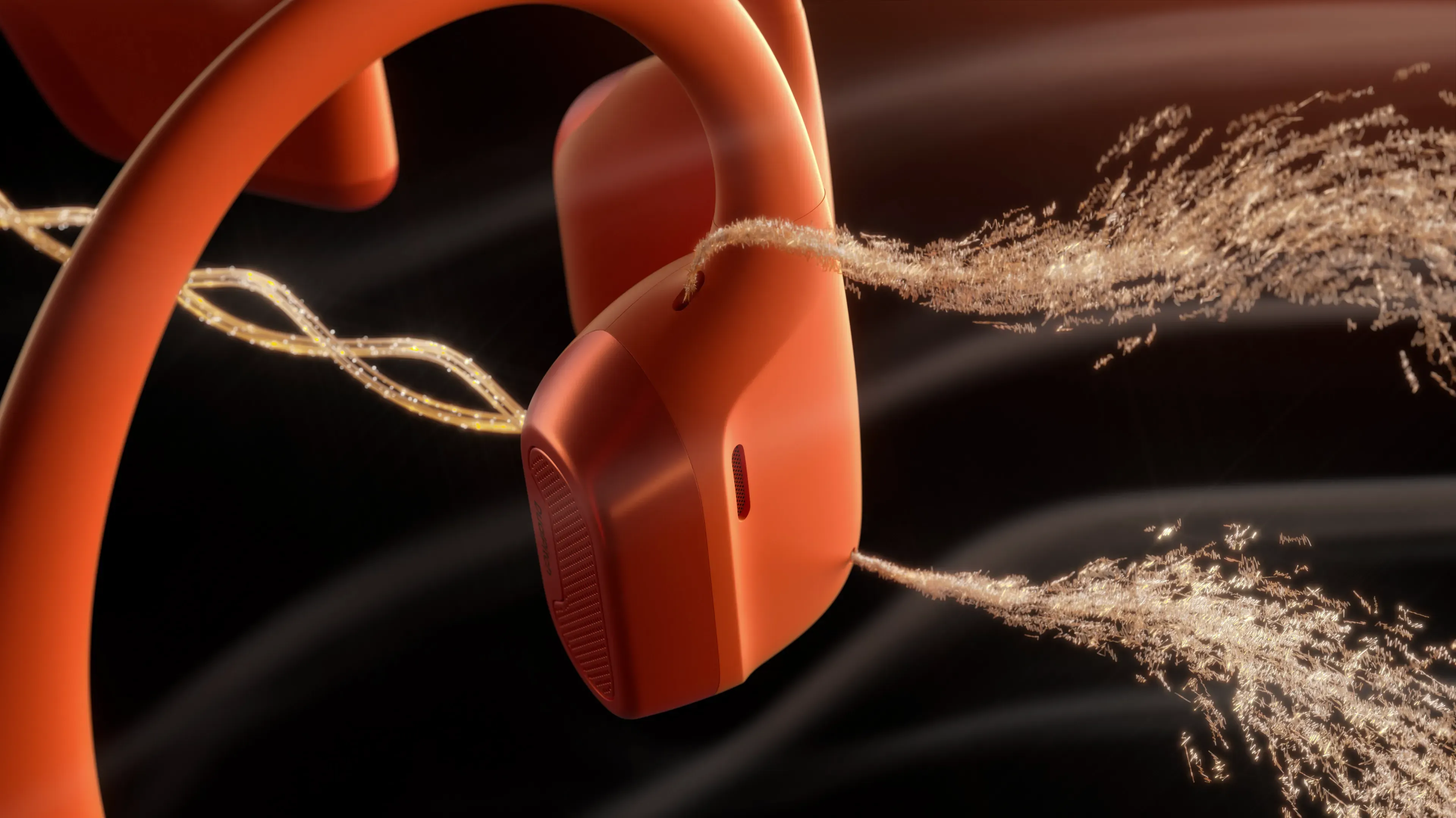 Vue macro d'un casque à conduction osseuse orange avec effets visuels d'ondes vibratoires et particules lumineuses en arrière-plan, illustrant le principe de transmission mécanique du son à travers les os du crâne