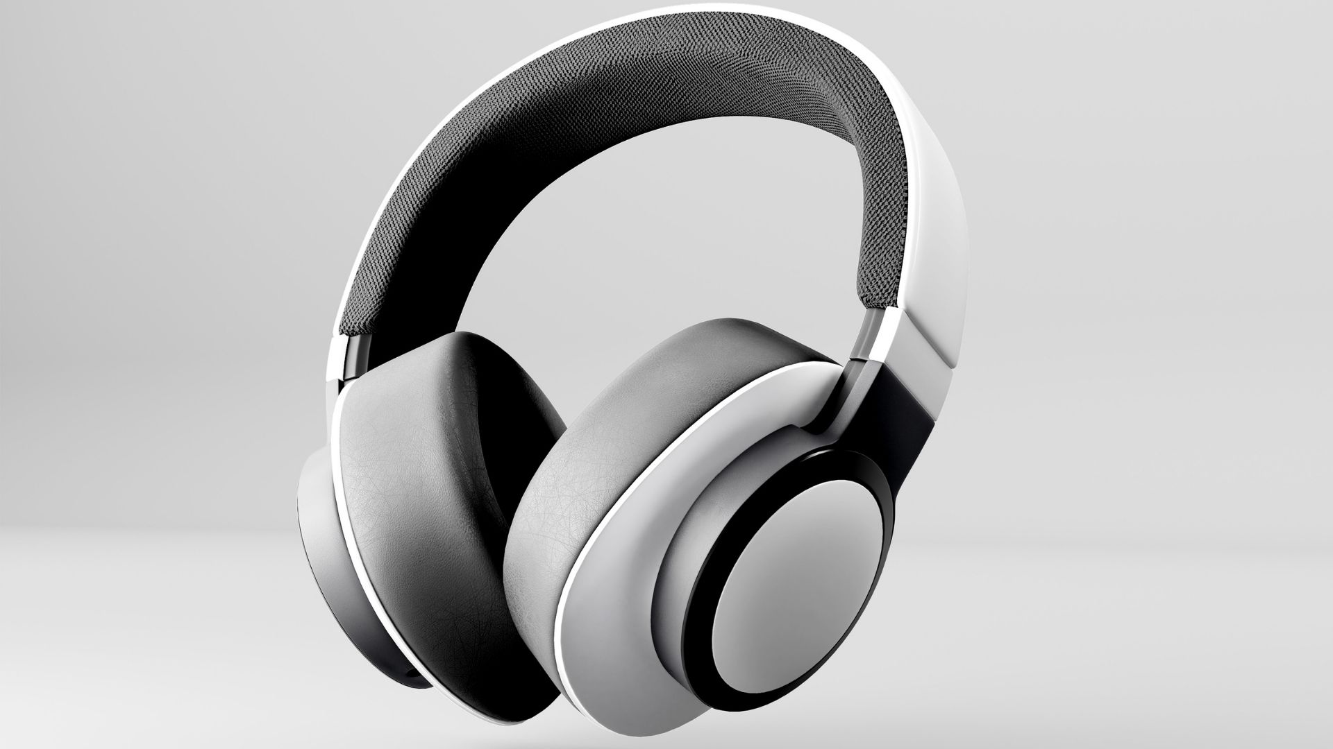 Auriculares circumaurales blancos y grises en plano de estudio sobre fondo claro, vista de tres cuartos que pone en valor el arceau acolchado y los coussinets en mousse à mémoire
